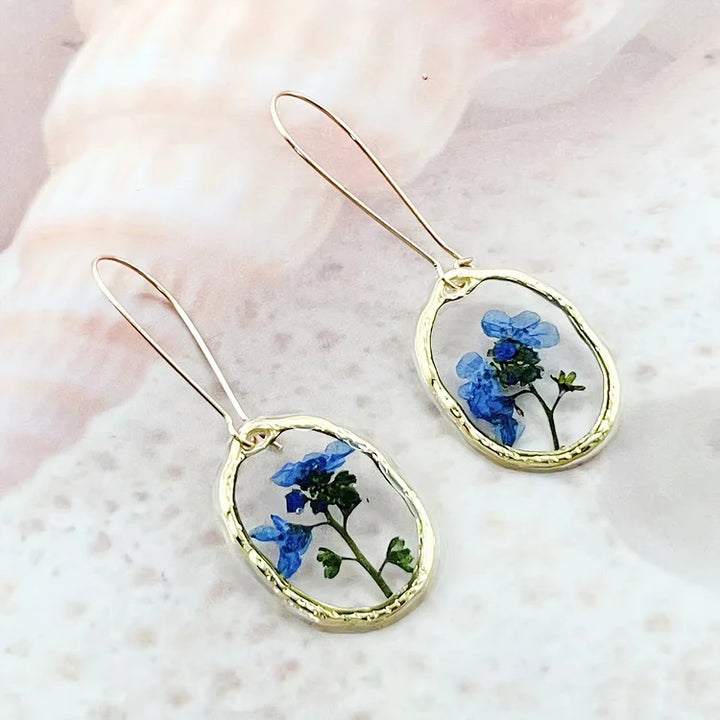 Brincos vibrantes de flor miosótis